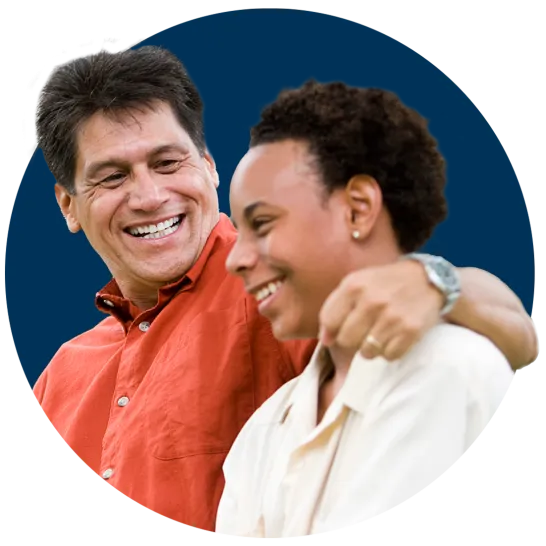 Smiling father with his arm around teenage son
