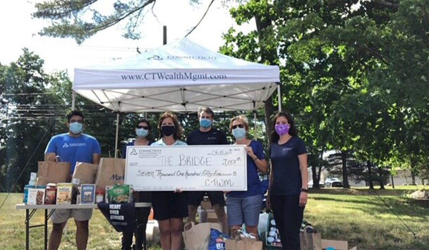 Volunteers holding big check