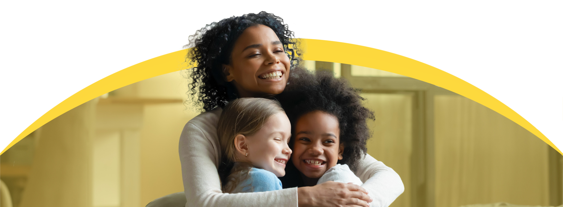Smiling mother hugging two smiling children