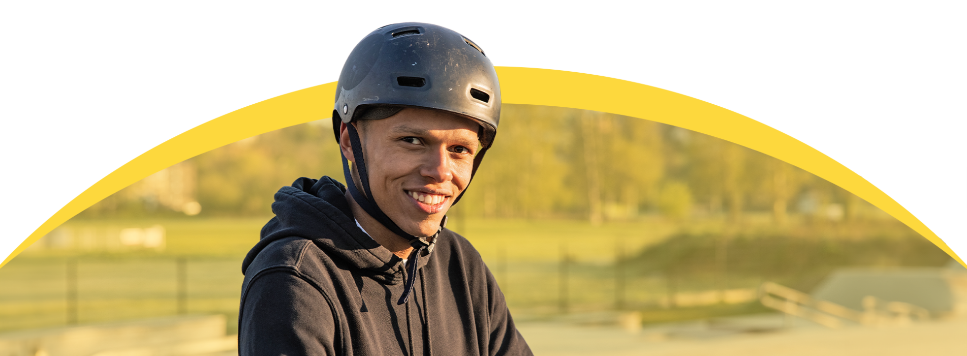 Teenager smiling wearing bike helmet