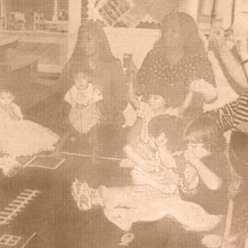 Toddlers and mothers sitting in circle