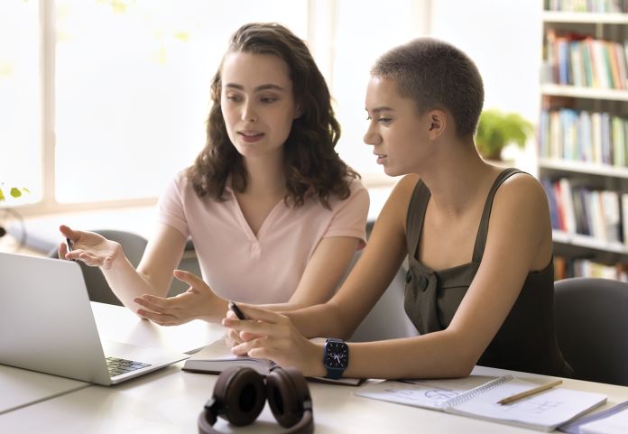 Two girls looking at computer