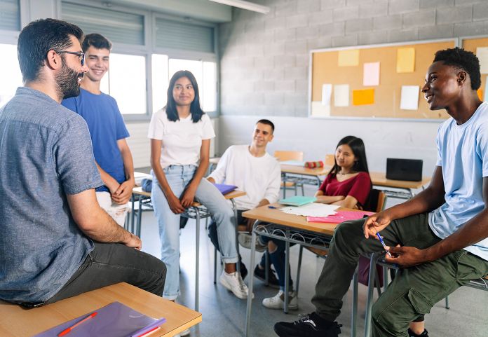 high school teens meeting with teacher