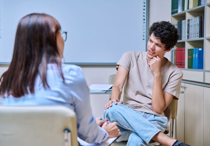 Teen speaking with mentor