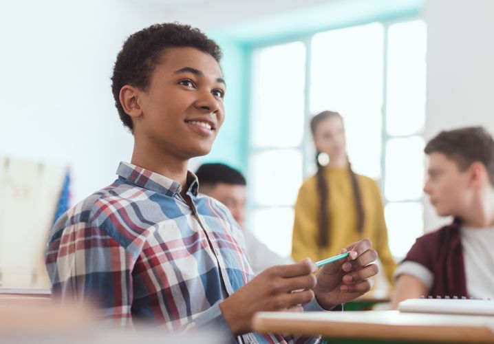 Smiling boy sitting at desk