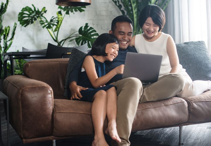 Parents with child on computer