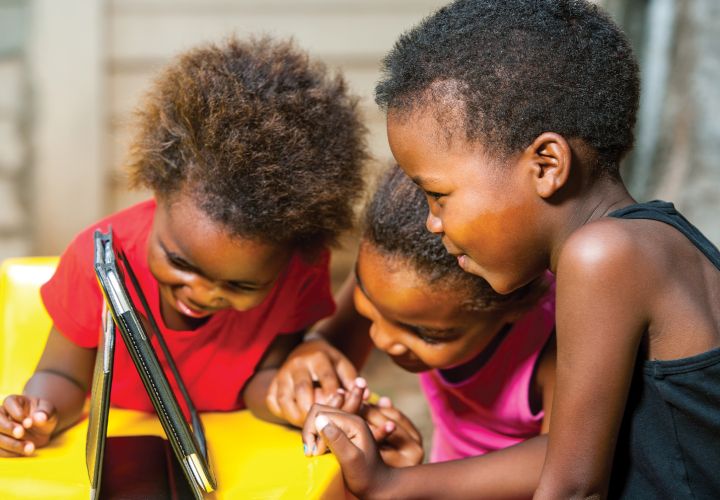Children looking at iPad