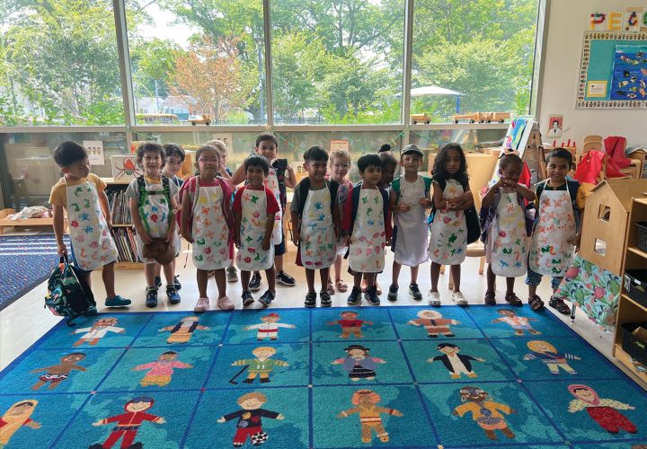 Class of children wearing paint aprons