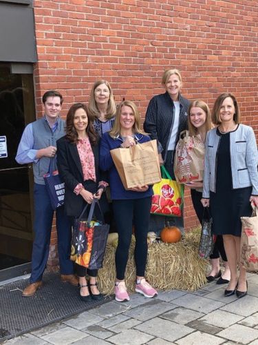 Volunteers holding grocery bags