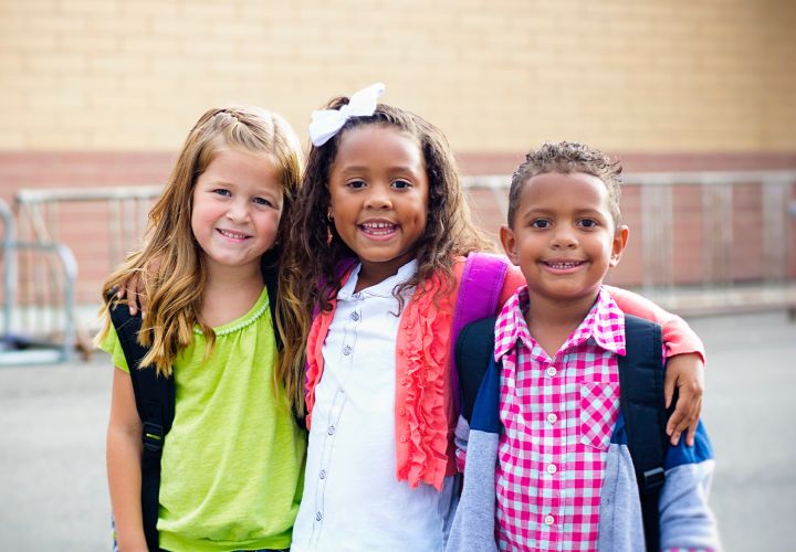 Children with backpacks on at school