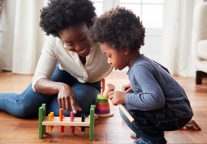 Mother and toddler playing with toy