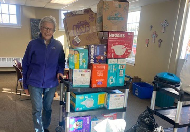 Volunteer with baby supplies
